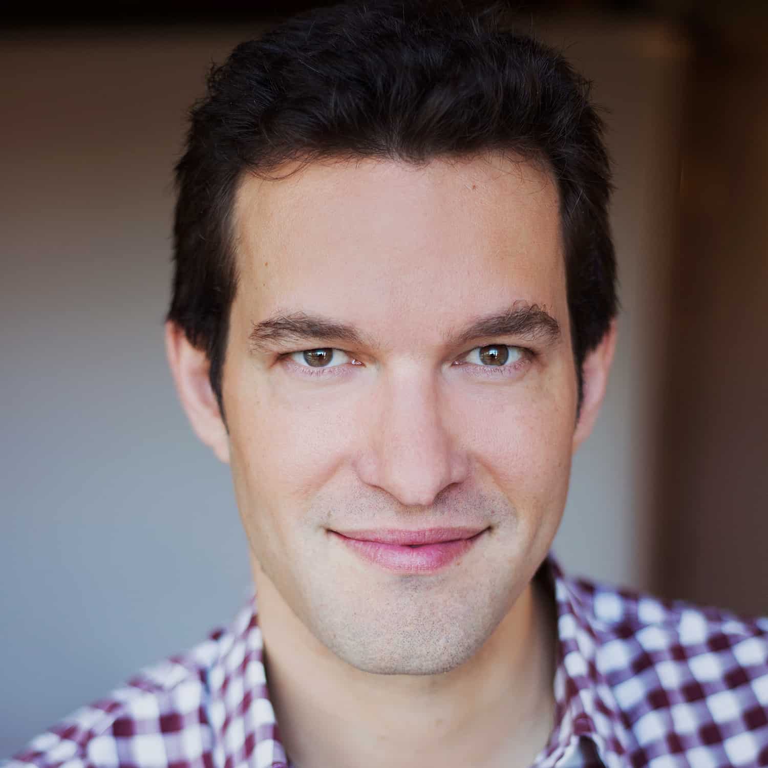 Antoine Gervais wearing a checkered button down shirt