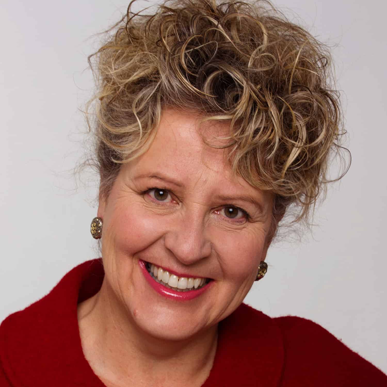 April Lindgren wearing a red top and smiling