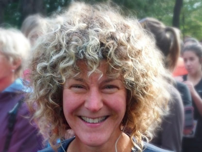 Diane Berard with lively curly hair smiling