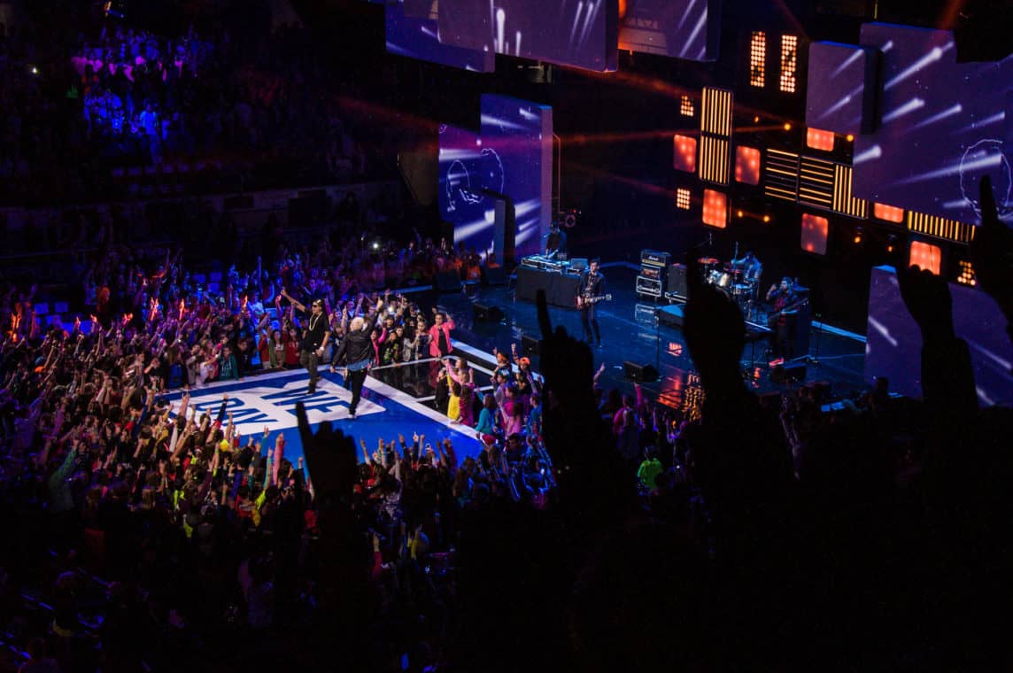 Picture of a WE Day event with large crowd and performers on stage.