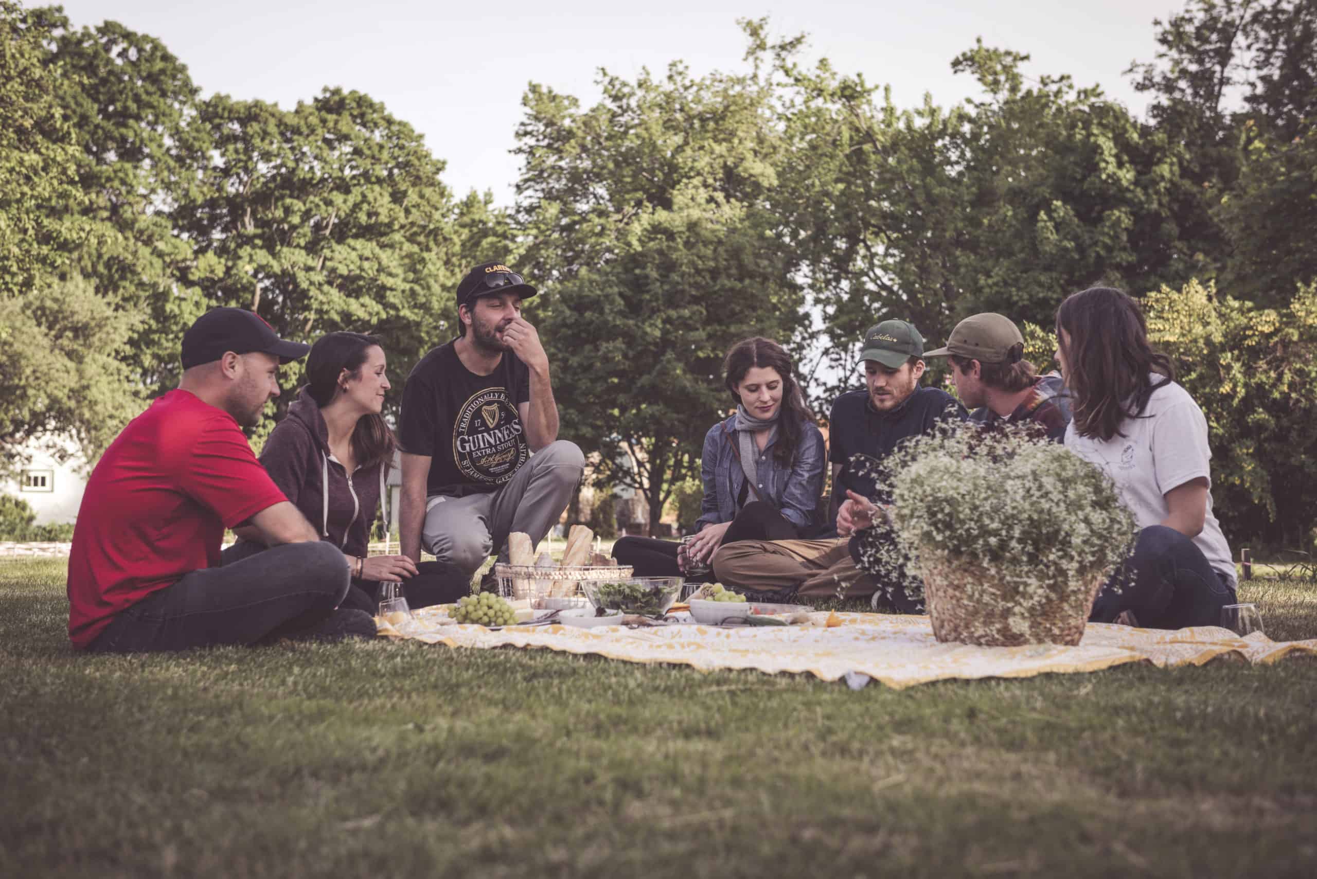 People picnicking in the field behind Maison Mère
