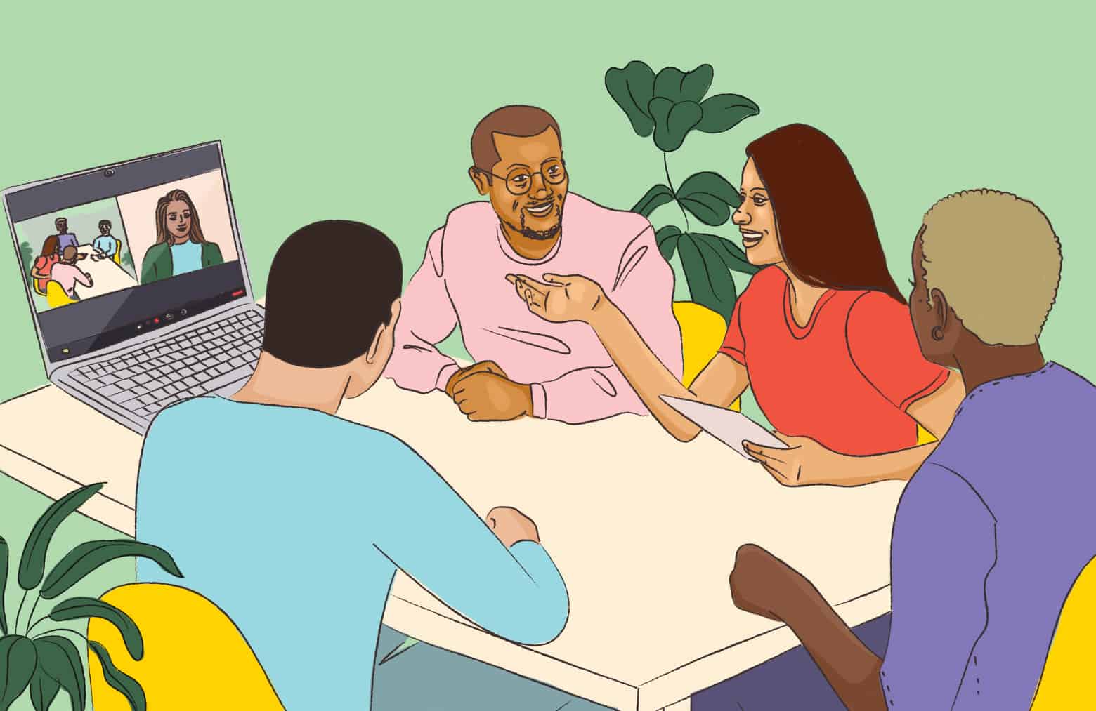 A group of people sitting around a table talking with another person participating on a computer screen.