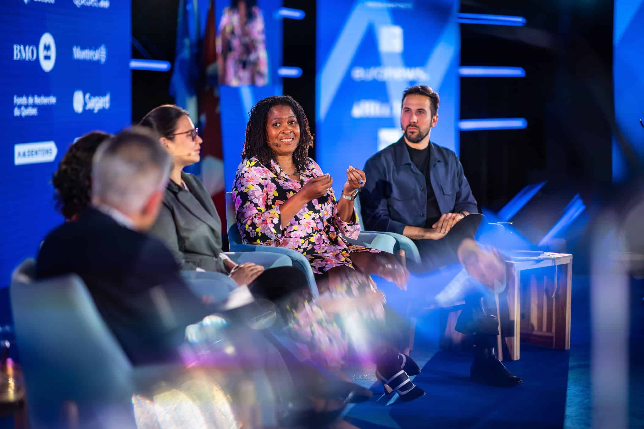 Five panelists on a stage