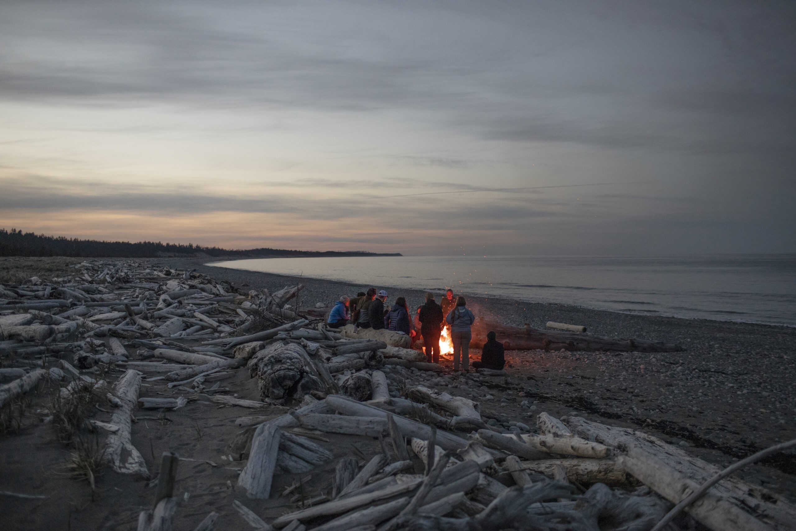 People around a fire on a beach