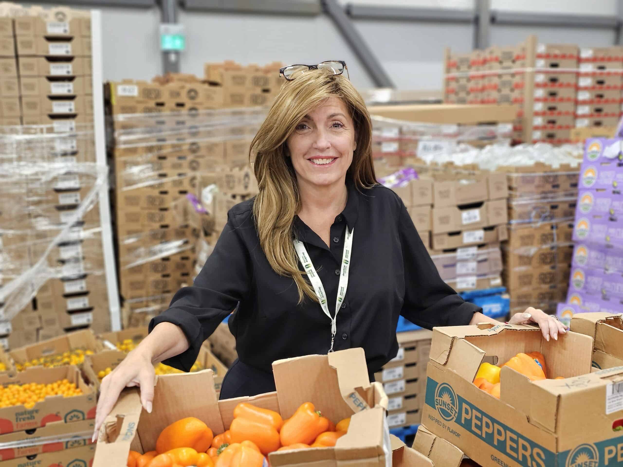 Second Harvest CEO Lori Nikkel with food donations