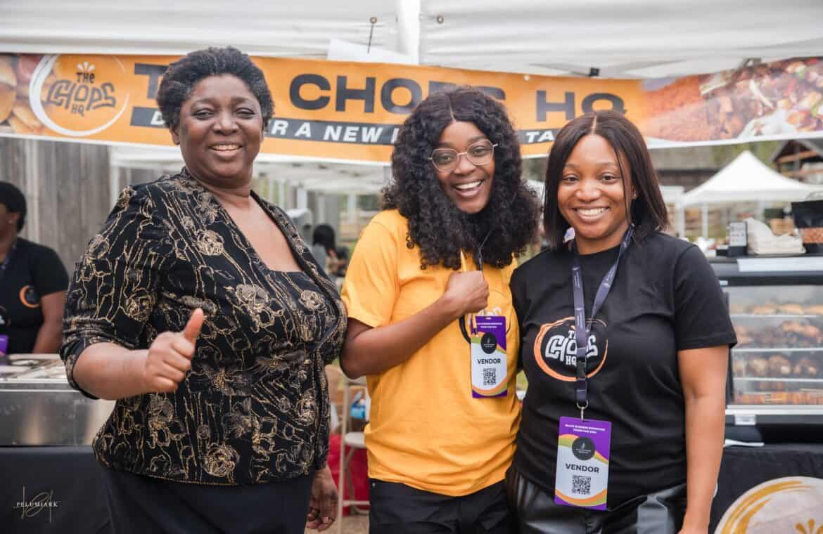 Three women posing with smiles. Two are wearing conference tags that say "vendor."