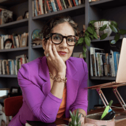 Photo of Annahid Dashtgard sitting at a desk in front of her laptop.