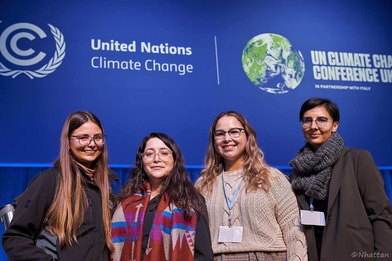 Photo of four women in front of a sign that reads "United Nations Climate Change."