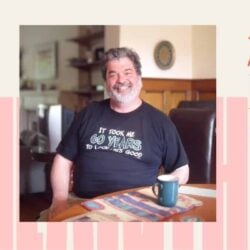 Photo of Nathan Gilbert sitting at a table smiling. There is a frame around the picture that says, "Remembering Nathan Gilbert"